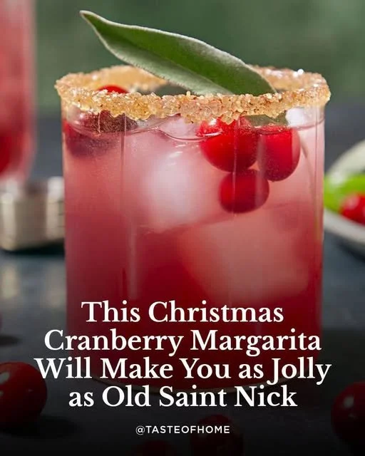A vibrant cranberry margarita served in a glass with a lime garnish.