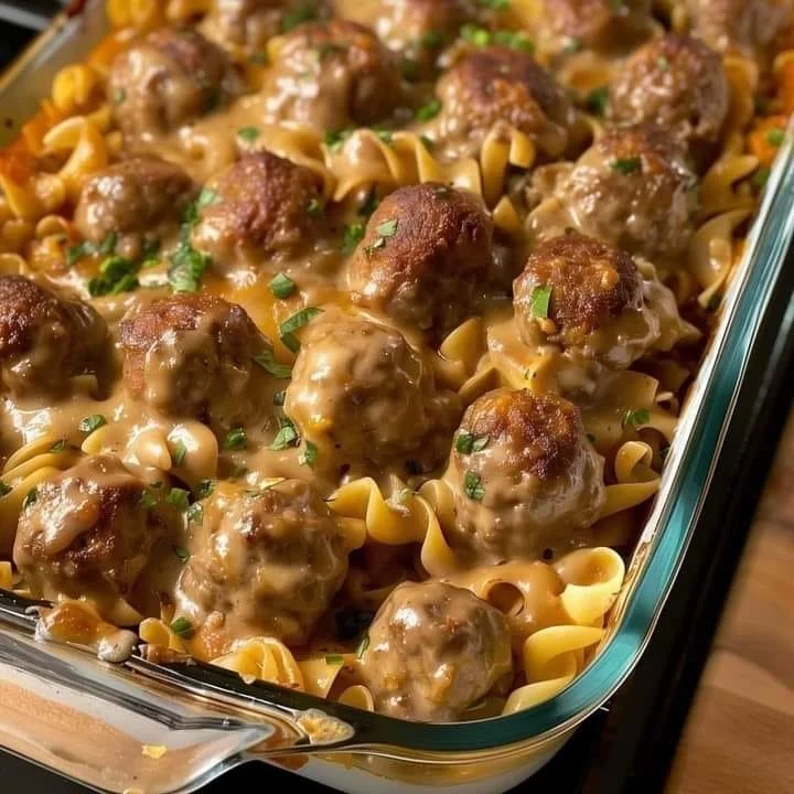 Delicious creamy meatball noodle dish topped with herbs.