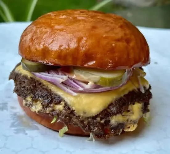 Delicious Smash Burger with toppings and melted cheese on a bun