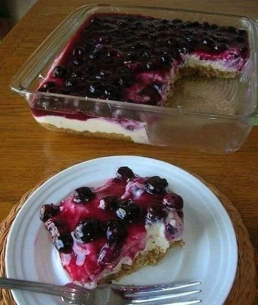 Delicious slice of blueberry cheesecake topped with fresh blueberries