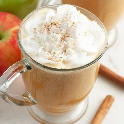 Delicious caramel apple cider served in a mug with cinnamon sticks