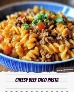 Cheesy beef taco pasta served in a vibrant bowl, topped with fresh ingredients.