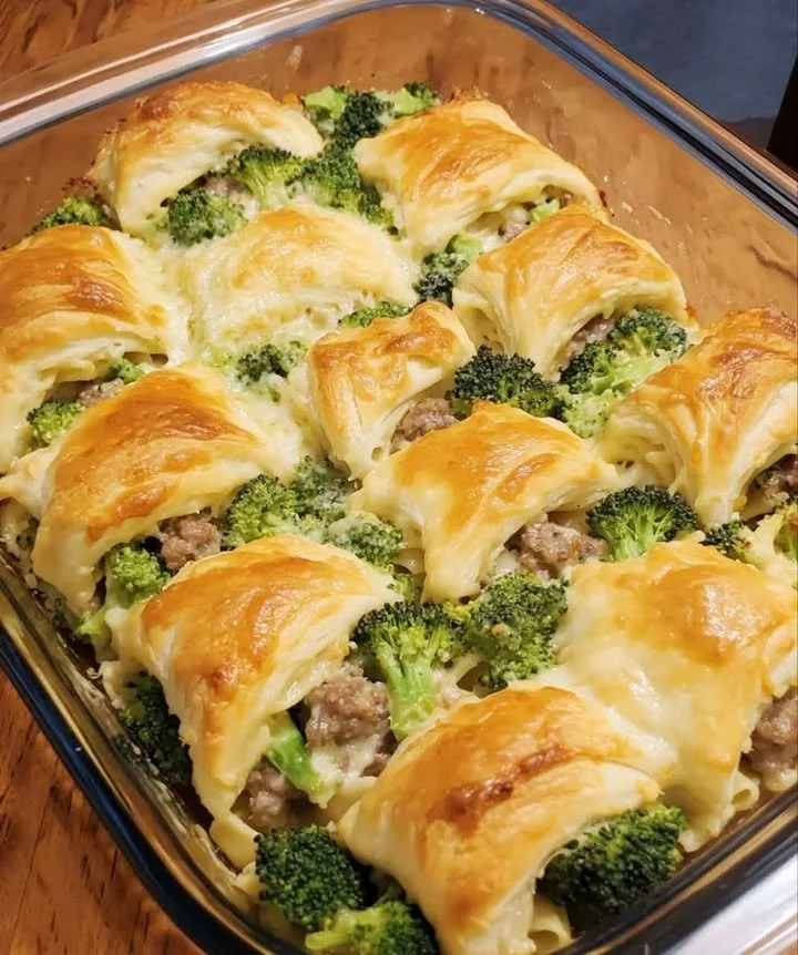 Cheesy sausage and broccoli pasta bake topped with melted cheese.