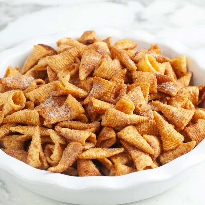 A bowl of Cinnamon Bugles snacks, showcasing their crunchy texture and delightful cinnamon flavor.