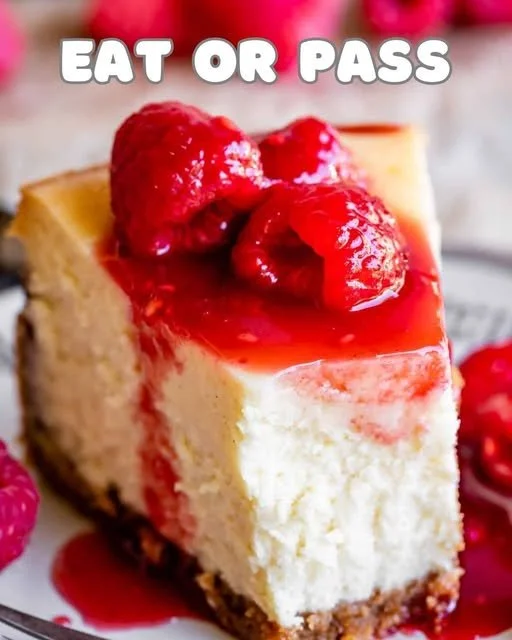 Classic cheesecake topped with fresh berries on a white plate