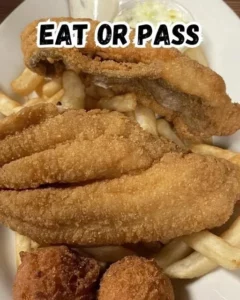A plate of classic fried catfish served with lemon and tartar sauce