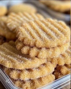 A variety of colorful cookies on a wooden tray, showcasing different flavors and textures.