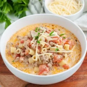 Bowl of creamy Italian sausage soup garnished with fresh herbs