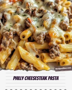 Plate of delicious Philly Cheesesteak Pasta topped with melted cheese and herbs