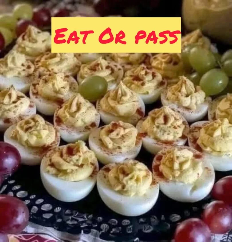 Plate of tasty deviled eggs, garnished with paprika and herbs