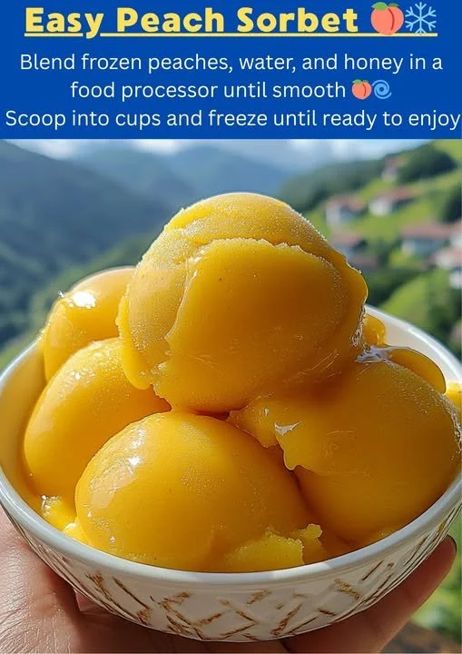 Homemade easy peach sorbet served in a bowl with fresh peaches