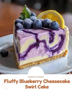 Fluffy blueberry cheesecake swirl cake topped with fresh blueberries and cream