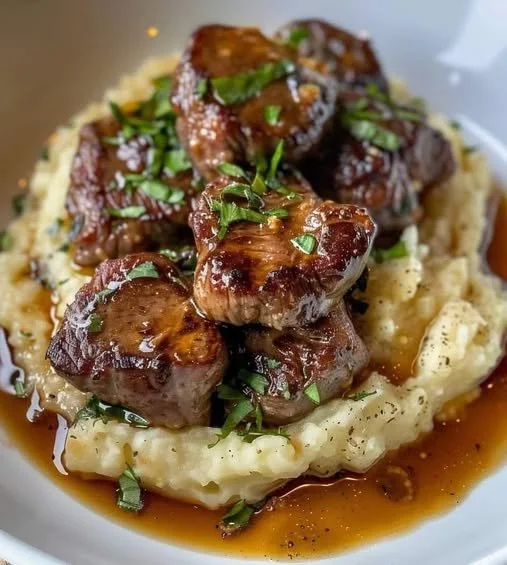Delicious Garlic Butter Steak Bites served with creamy mashed potatoes