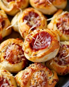 Plate of homemade pepperoni pizza rolls, golden brown and cheesy