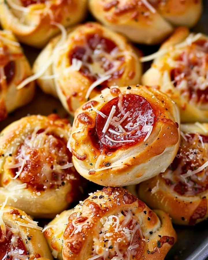 Plate of homemade pepperoni pizza rolls, golden brown and cheesy