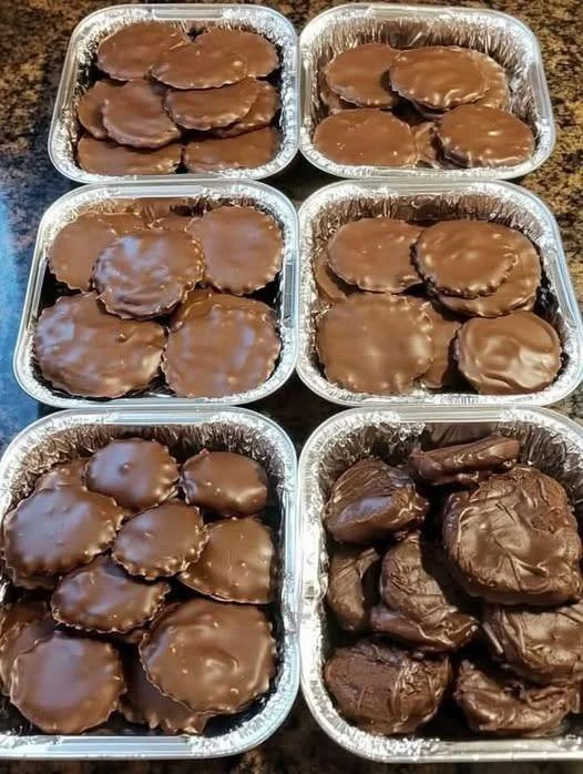 Homemade turtle candy with pecans and caramel on a wooden table.
