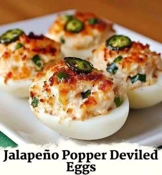 Delicious jalapeño popper deviled eggs topped with jalapeños and bacon