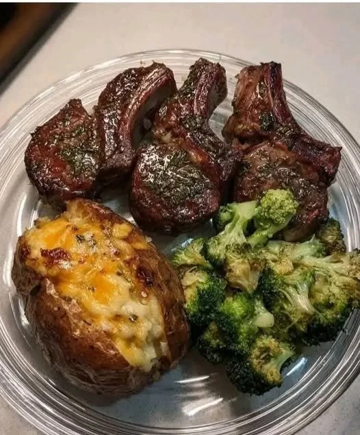Juicy lamb chops with a loaded baked potato and garlic broccoli on a plate