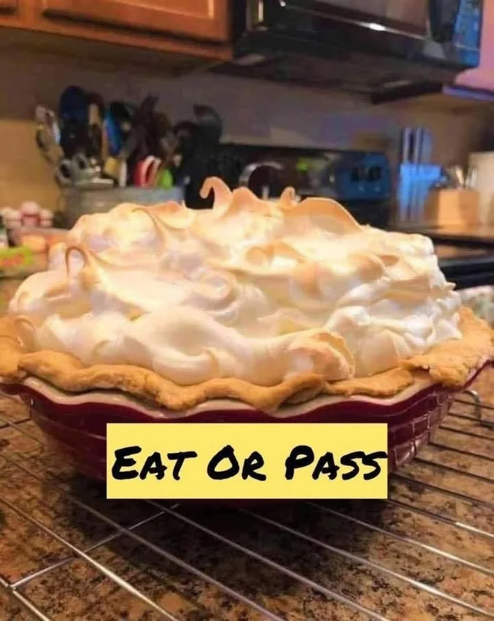 Slice of homemade Lemon Meringue Pie with golden meringue topping on a white plate.
