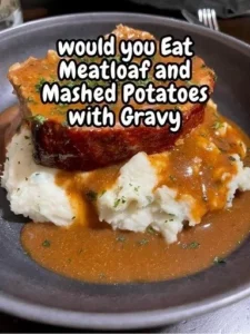 Meatloaf with mashed potatoes and gravy on a plate