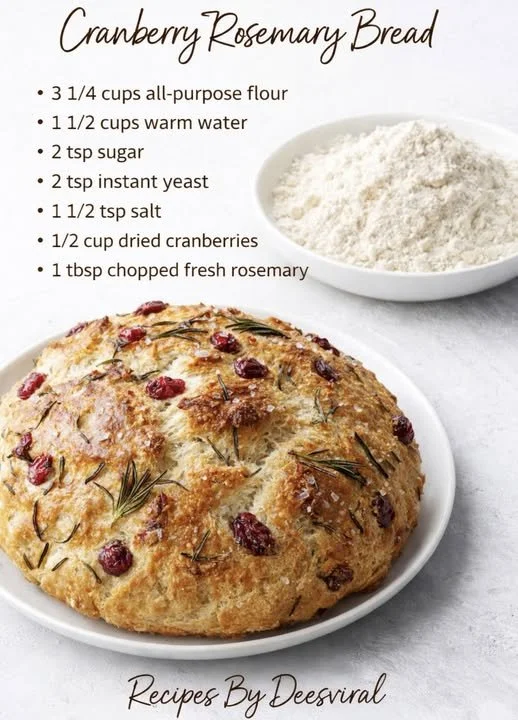 No-knead rosemary cranberry bread with herbs and cranberries in a loaf shape.