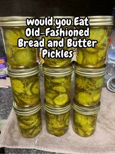 Jar of homemade old-fashioned bread and butter pickles on a wooden table