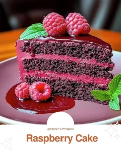 Delicious Raspberry Cake topped with fresh berries and whipped cream