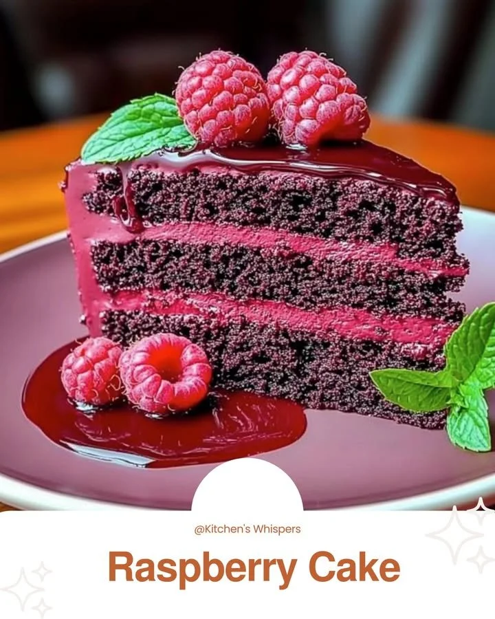 Delicious Raspberry Cake topped with fresh berries and whipped cream