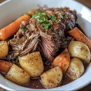 Delicious slow cooker pot roast served with carrots and potatoes