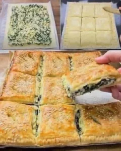 Spinach and cheese puff pastry squares on a plate, garnished with herbs