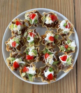 Plate of delicious taco bites served with dipping sauce