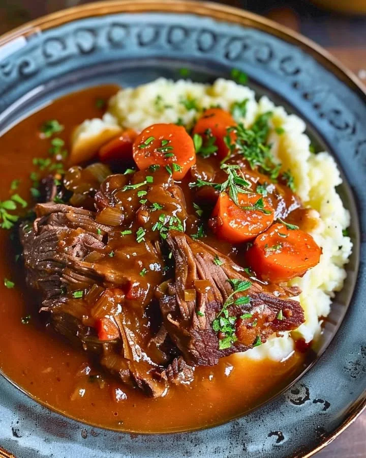 Delicious pot roast served with rich gravy on a plate