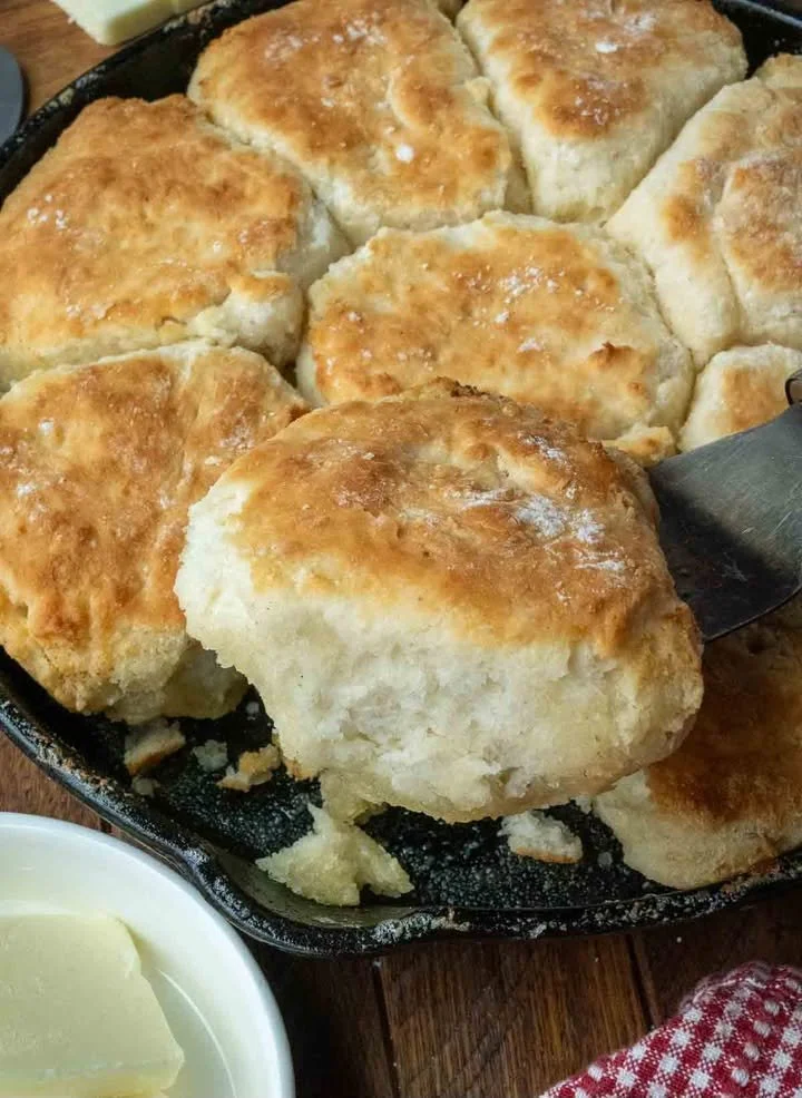 Fluffy 7-Up Biscuits served with butter on a plate