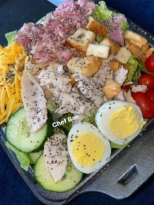A variety of healthy snacks including fruits, nuts, and snacks on a wooden table.