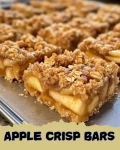 Homemade Apple Crisp Bars topped with crumbles and fresh apple slices.