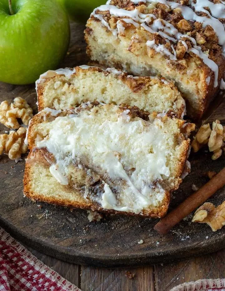 Delicious apple fritter bread with chunks of apple on a wooden table.