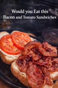 Delicious bacon and tomato sandwiches on a wooden plate.