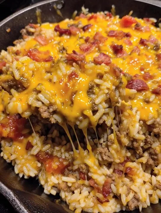 Delicious Bacon Cheeseburger Rice Skillet served in a pan, showcasing cheese, bacon, and rice