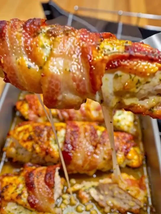 Bacon Garlic Parmesan Chicken garnished with herbs on a white plate