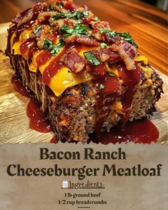 Delicious Bacon Ranch Cheeseburger Meatloaf garnished with bacon and ranch dressing.