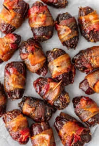 Bacon wrapped dates filled with goat cheese, ready to serve as an elegant appetizer.