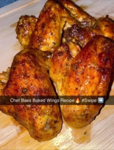 Delicious Baes baked chicken wings served on a platter with dipping sauce.