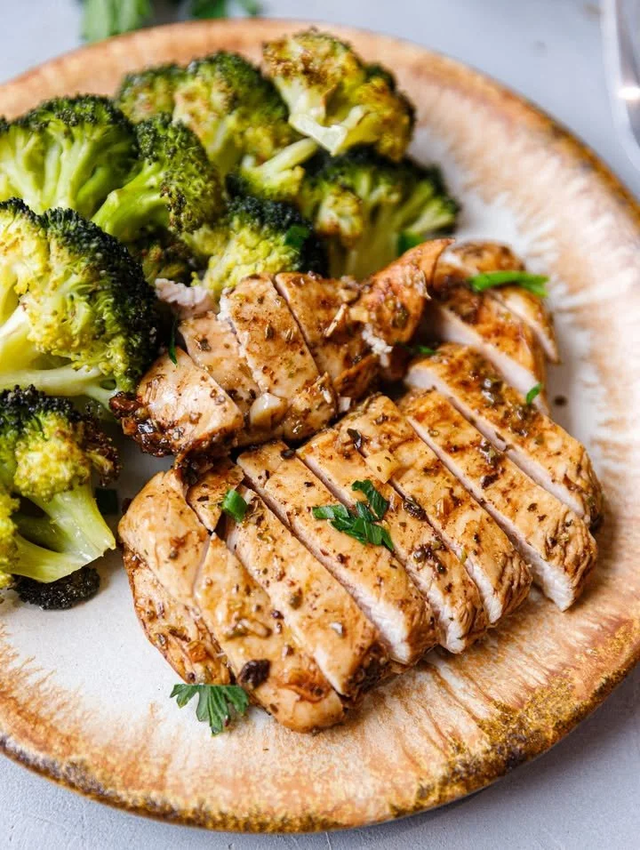 Baked Balsamic Chicken Breast with herbs and vegetables on a plate