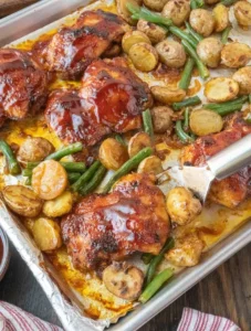 Baked chicken served with potatoes and green beans on a dinner plate