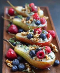 Baked pears topped with blue cheese, walnuts, and fresh berries