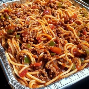 Cheesy baked spaghetti with meat sauce in a casserole dish, ready to serve.
