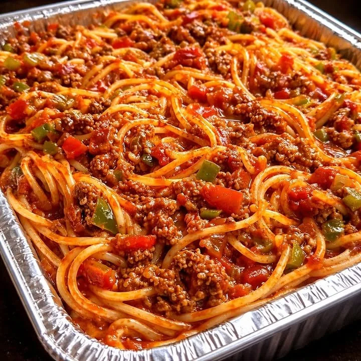 Delicious baked spaghetti with meat sauce served in a baking dish