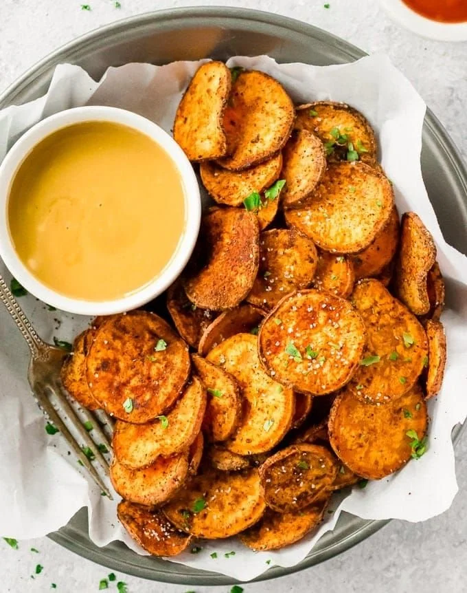 Crispy baked sweet potato chips served in a bowl as a healthy snack option