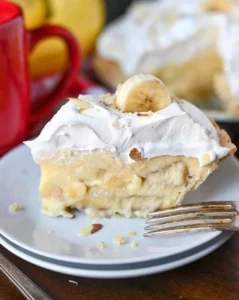 Delicious banana cream pie with fresh bananas and cream topping