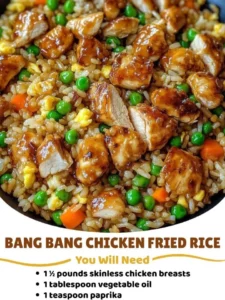 Plate of Bang Bang Chicken Fried Rice garnished with green onions and sesame seeds